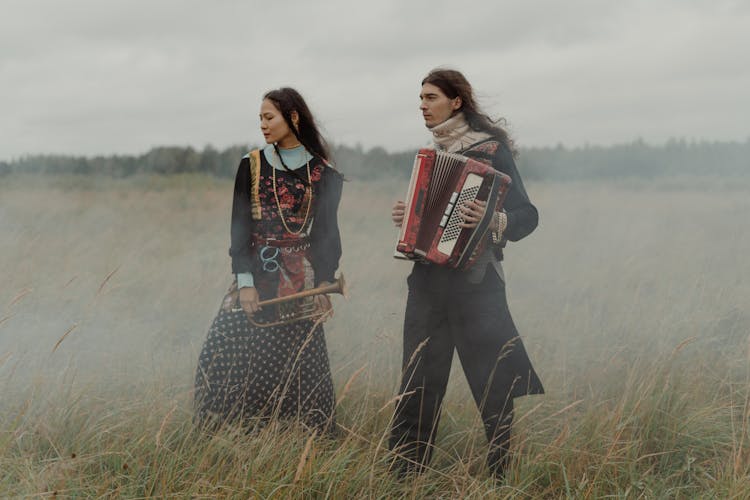 Gypsies With Musical Instruments At A Grass Field