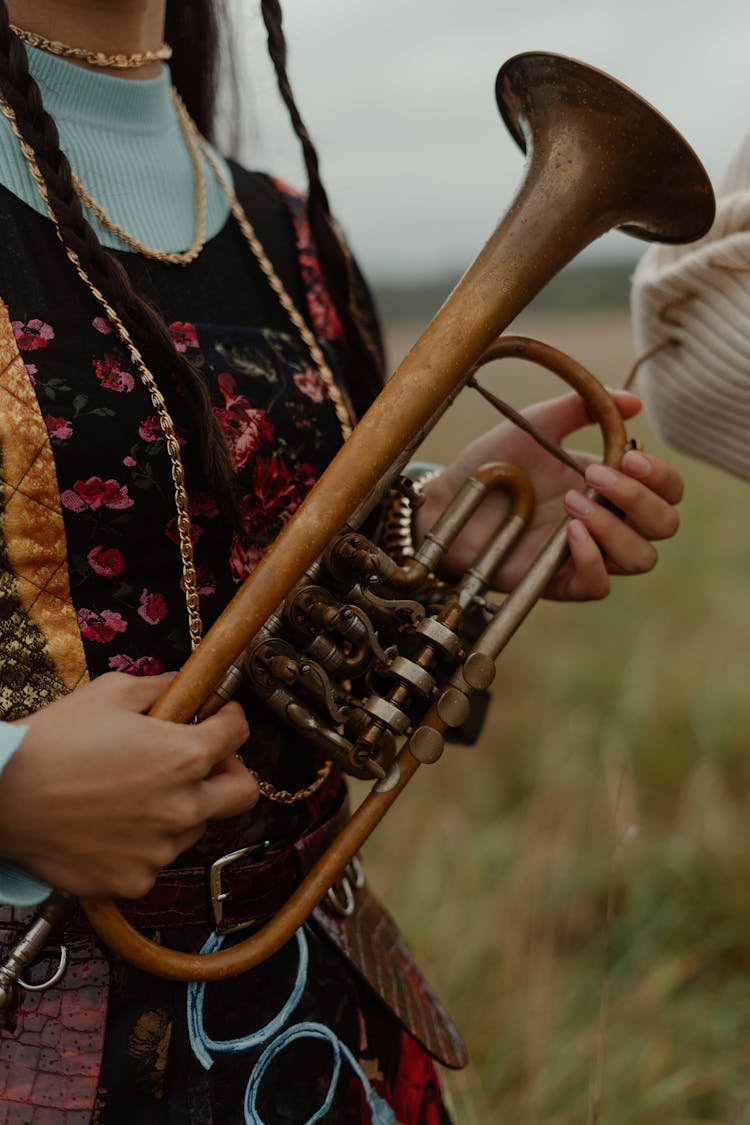 A Woman Holding A Trumpet