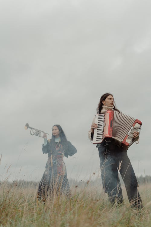 Free Musicians at a Grassy Field Under the Cloudy Sky Stock Photo
