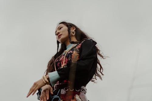 Woman in Black and Red Floral Long Sleeve Shirt under Gloomy Sky