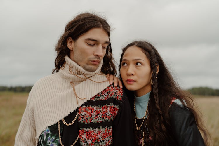 A Man And A Woman In Stylish Sweaters