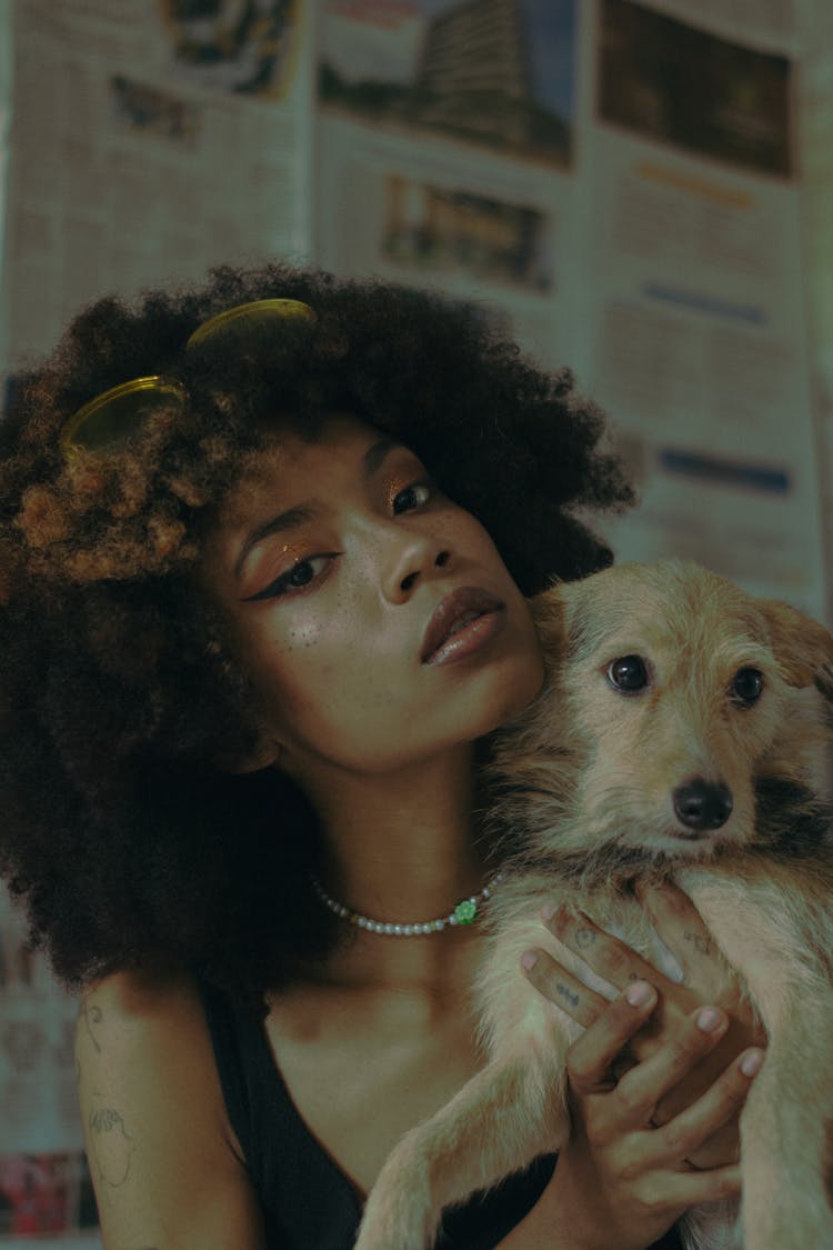 Portrait Of Curly Haired Woman Holding Dog