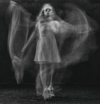A captivating black and white image of a blurred dancing woman, creating an ethereal feel.