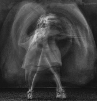 Expressive motion blur capturing a dancing figure in elegant monochrome.
