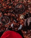 Boy in Black Jacket and Black Pants Standing Beside Black Bicycle