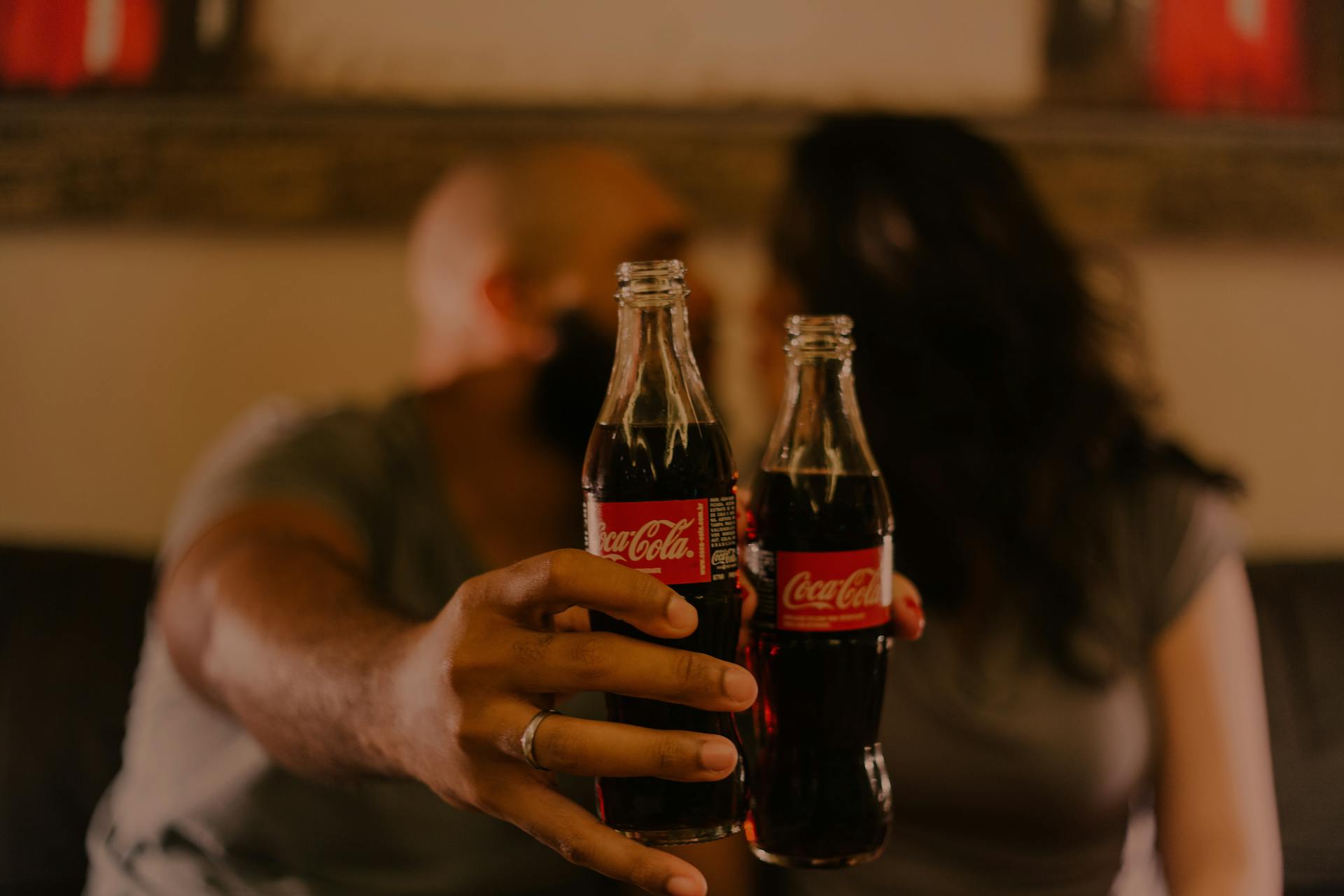 Close-Up Photography of People Holding Coca-Cola Bottles