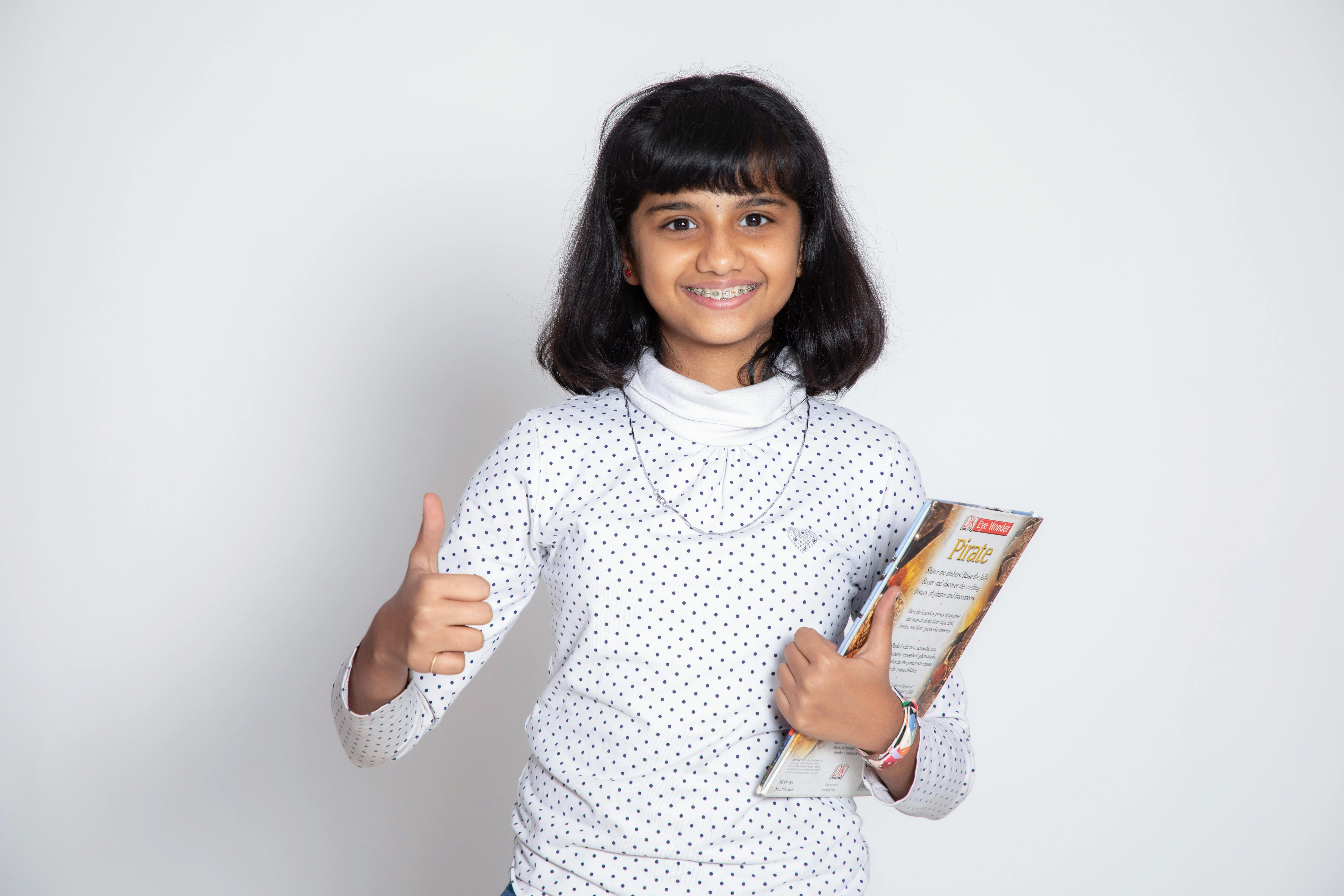 girl wearing a polka dot long sleeve shirt