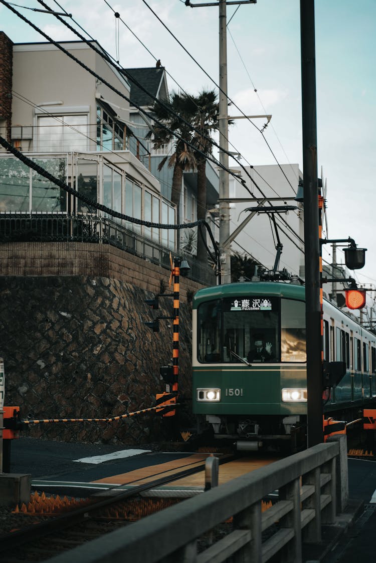 Train In City At Railway Crossing