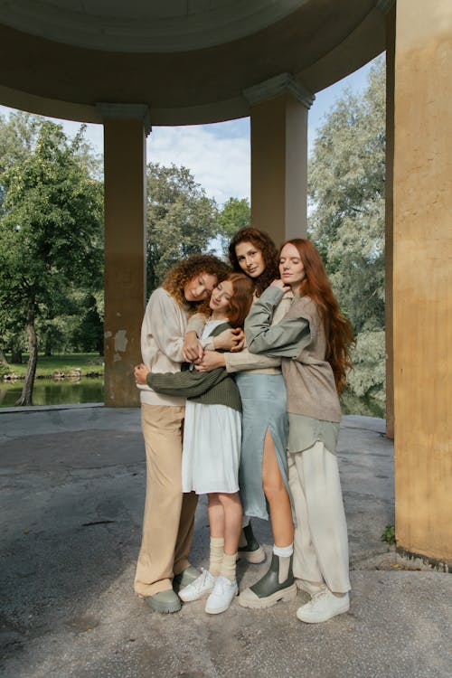 Four Female Friends Hugging in Park