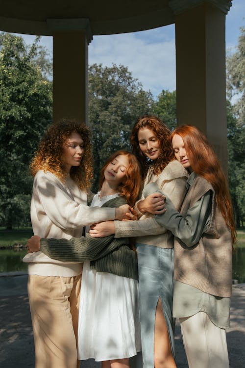 Free Four Female Friends Hugging in Park Stock Photo