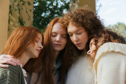 Free Three Female Friends Hugging in Park Stock Photo