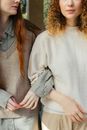 Mid Section of Two Female Friends Arm in Arm