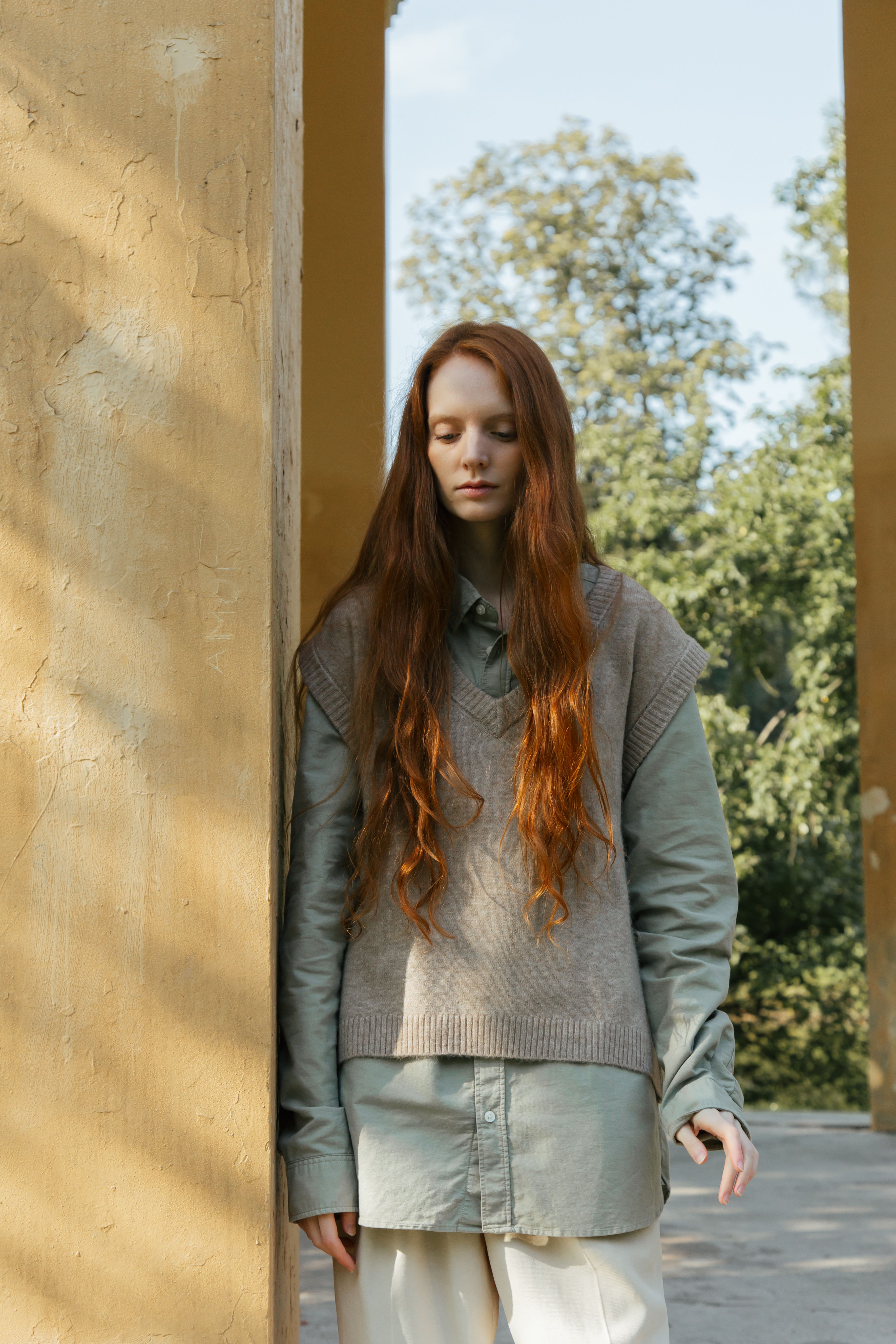 Pensive Redhead Woman Standing in Park · Free Stock Photo