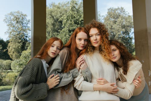 Portrait of Four Female Friends Hugging in Park