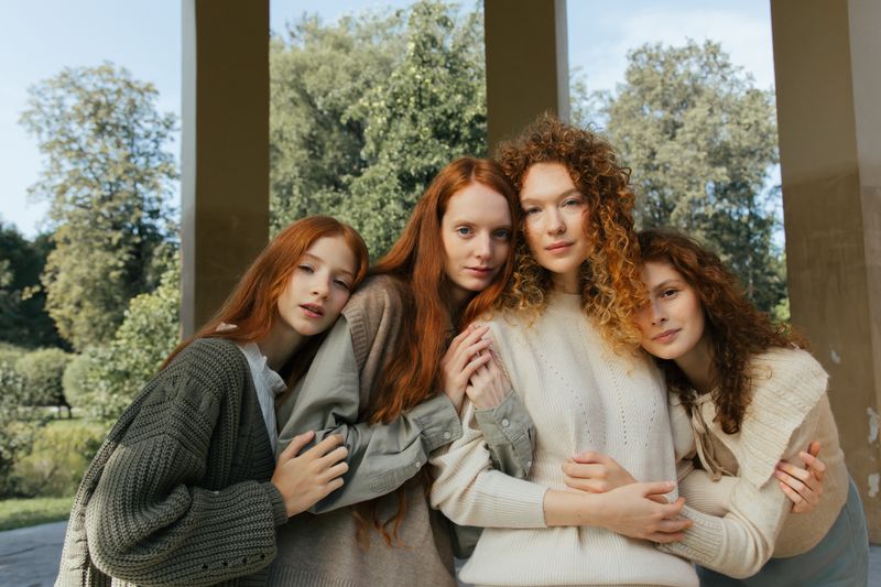 Four friends hugging and smiling in the park