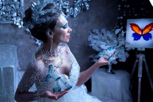 Artistic depiction of a woman in elegant fashion holding butterflies, exuding fantasy and grace.