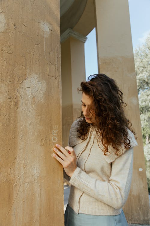 Pensive Woman Standing by Column