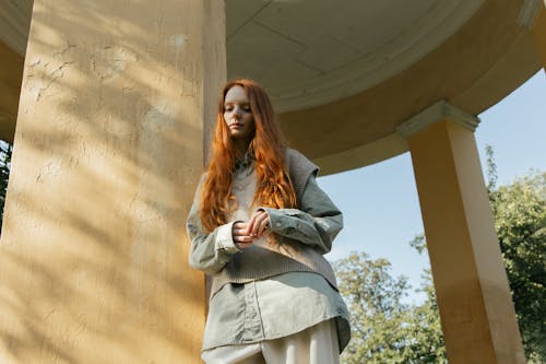 Low Angle View of Pensive Woman Standing by Column