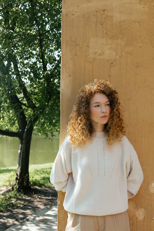 Pensive Woman Standing by Column