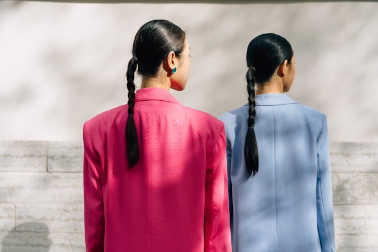 Women Wearing Blazers Near Concrete Wall