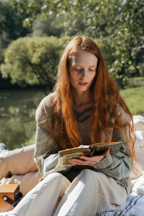 Woman Reading a Book in a Park