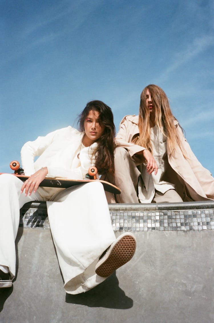 Women In White Clothes Sitting On Skate Ramp