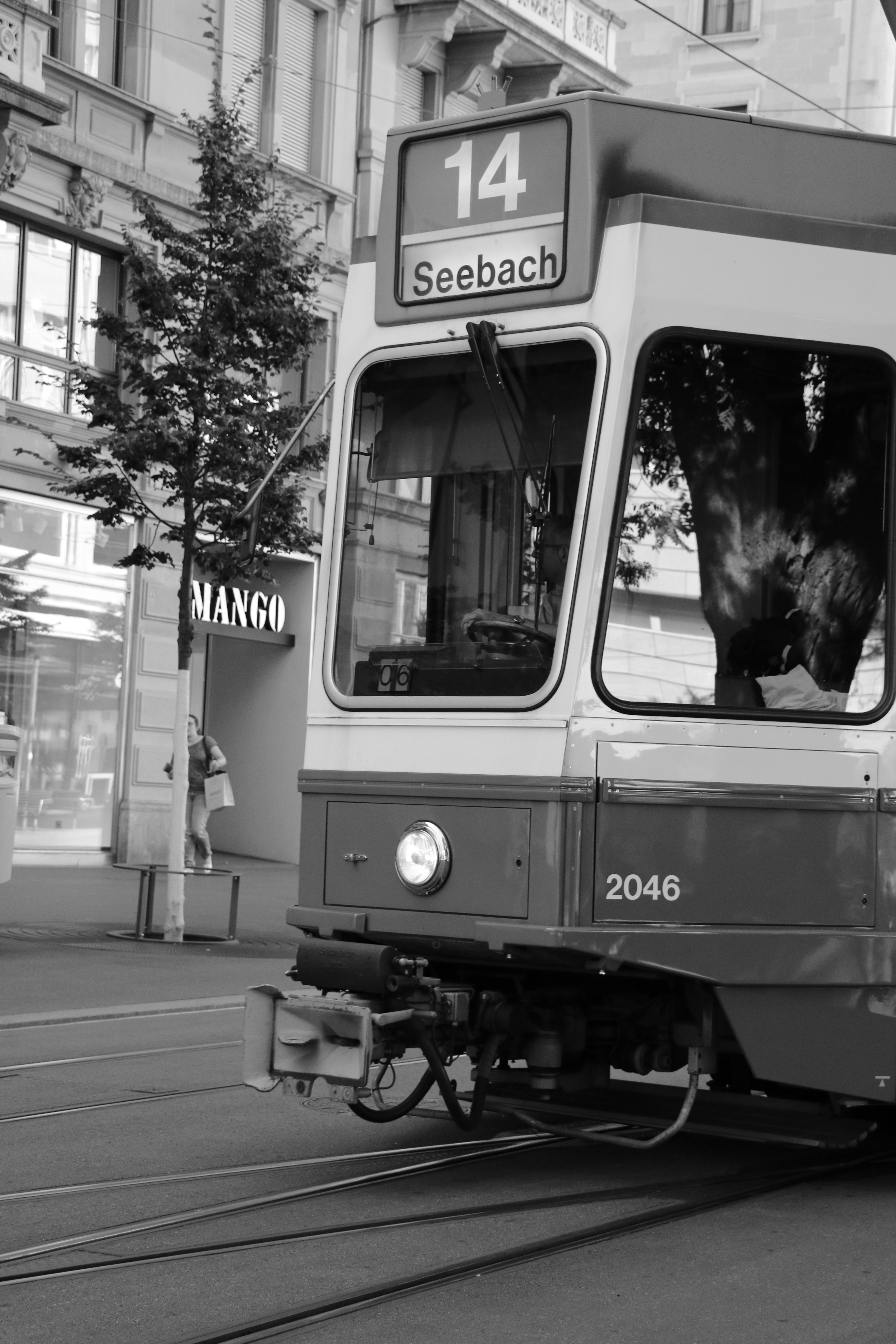 Monochrome photo of Zurich tram No. 14 in Seebach with urban backdrop.