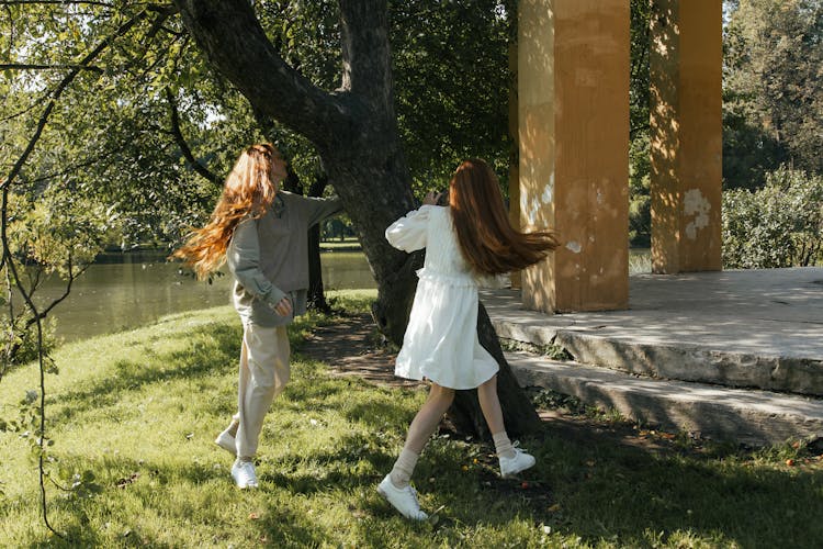 Women Running And Playing In Park