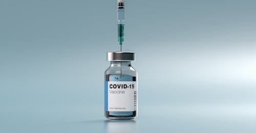 Free Syringe in a Vial of Vaccine Stock Photo