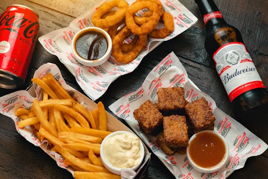 An appetizing assortment of fried foods with soft drinks, perfect for a casual meal.