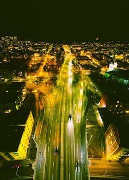 Stunning aerial night view of Stockholm, Sweden, showcasing illuminated roads and city lights.