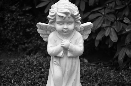 
A Grayscale of a Statue of a Baby Angel