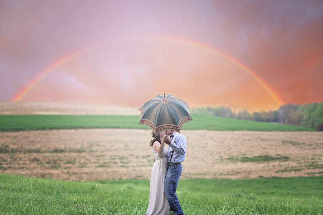 Free Photo of Couple Holding Umbrella While Kissing Stock Photo
