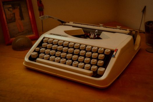 Retro typewriter on desk with nostalgic decor, evoking a vintage feel.