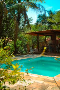 Lush tropical setting with pool and gazebo, perfect for relaxation in Brazil's natural beauty.