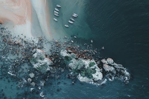 Rocky Beach and Boats on Shore 