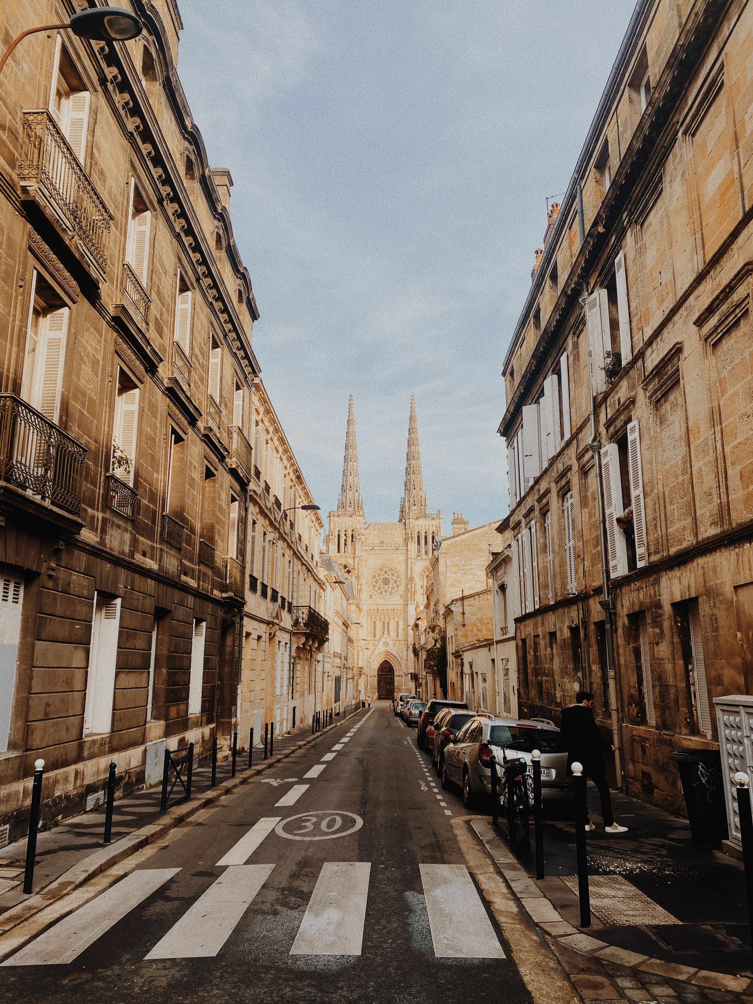 Charming street scene in Bordeaux, showcasing Cathédrale Saint-André and historic architecture.