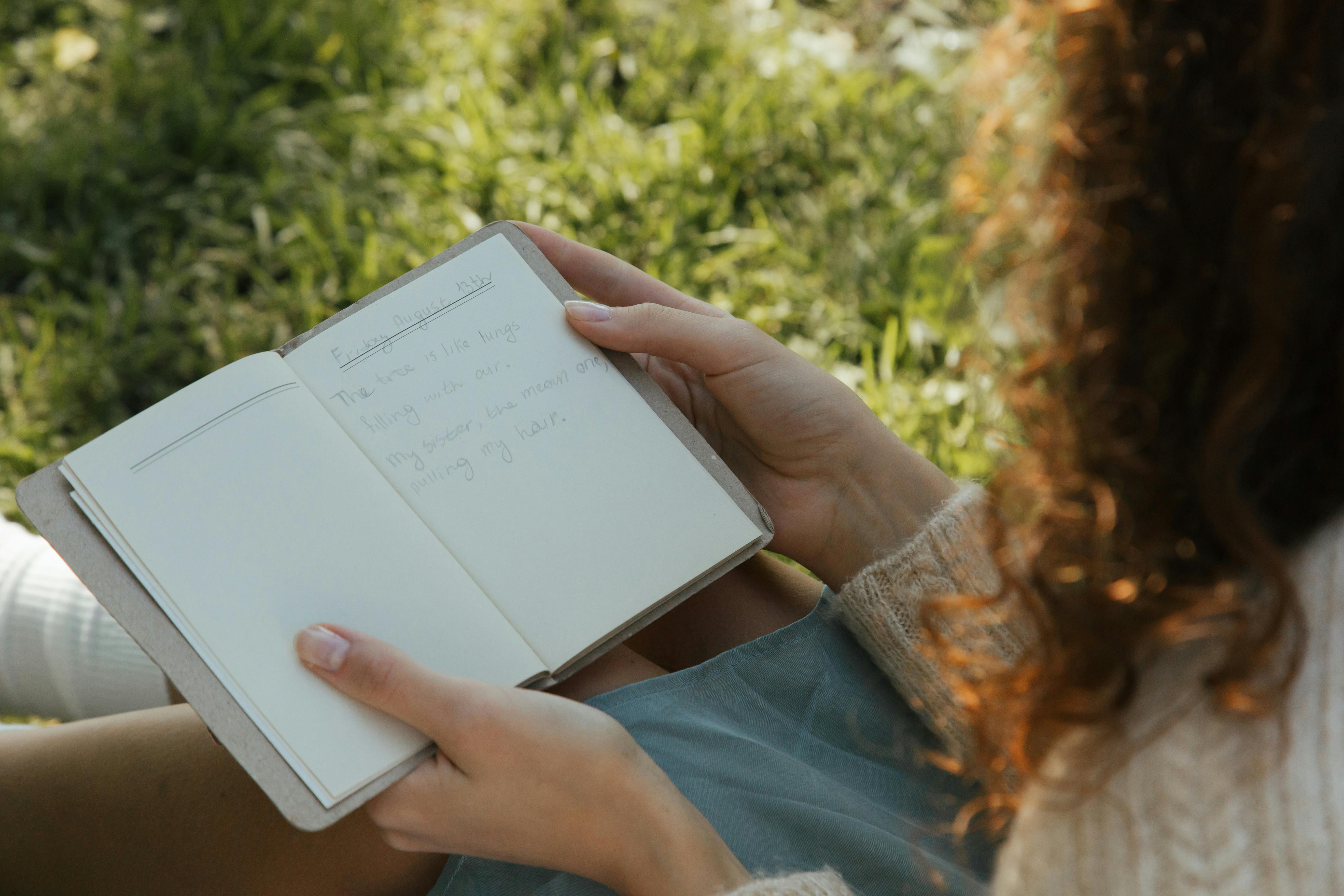woman reading her diary in a park