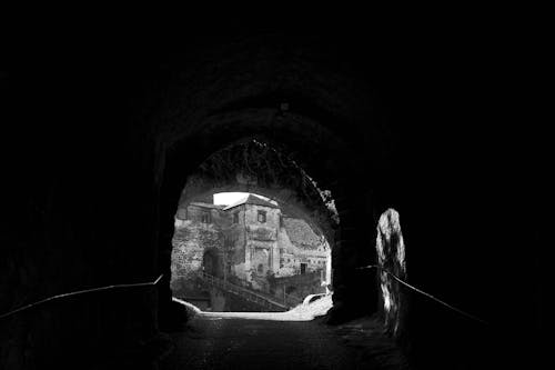 Free Grayscale Photo of Tunnel With Light Stock Photo