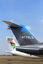 Two Airplanes on Land Under Blue Sky