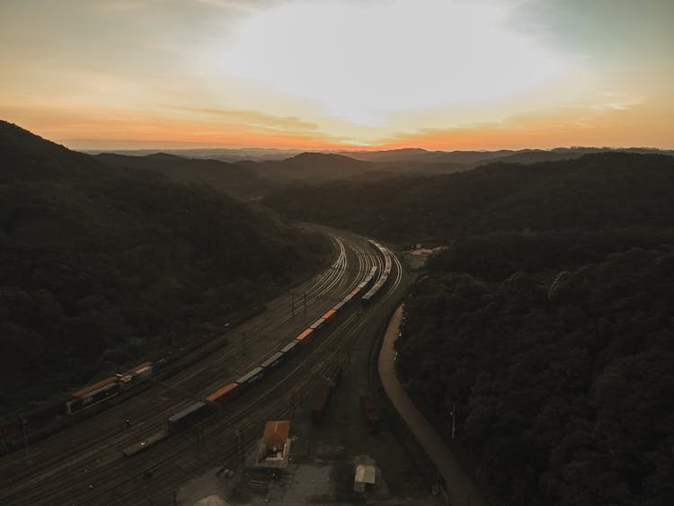 Trains On Rail Tracks At Dawn