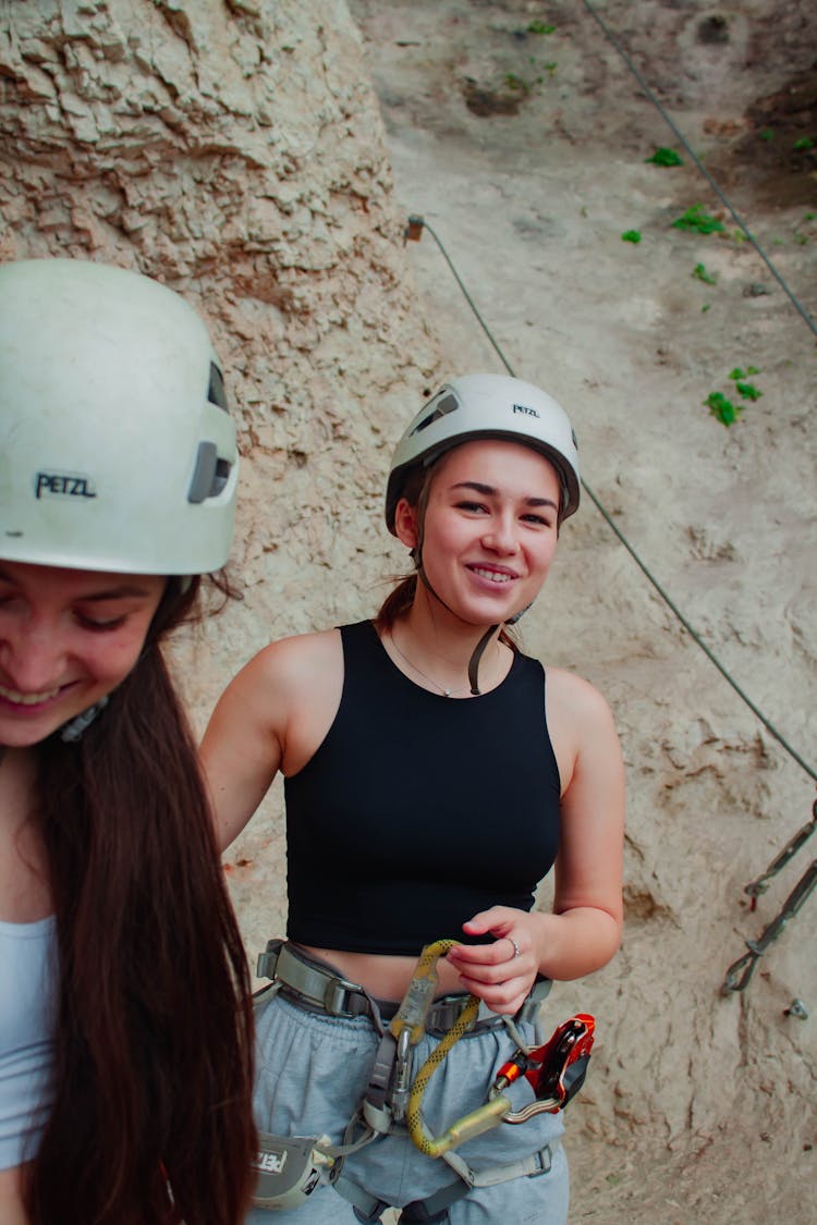 Women In Helmets Near Rock