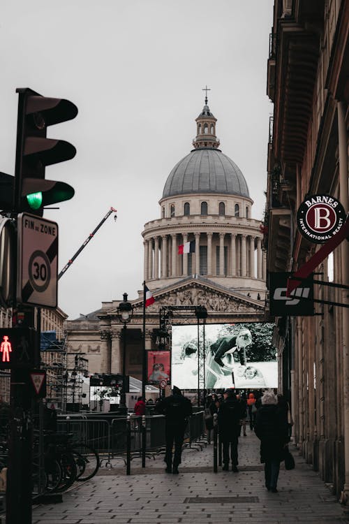 People Walking on Sidewalk in front of Majestic Building