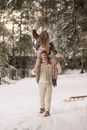 Man Giving Woman Piggyback Ride Through Snow