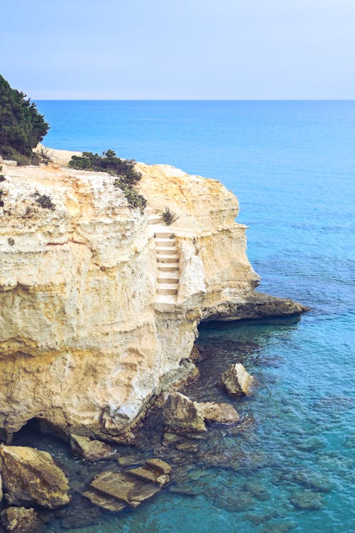 Brown Rock Formation Near Blue Sea