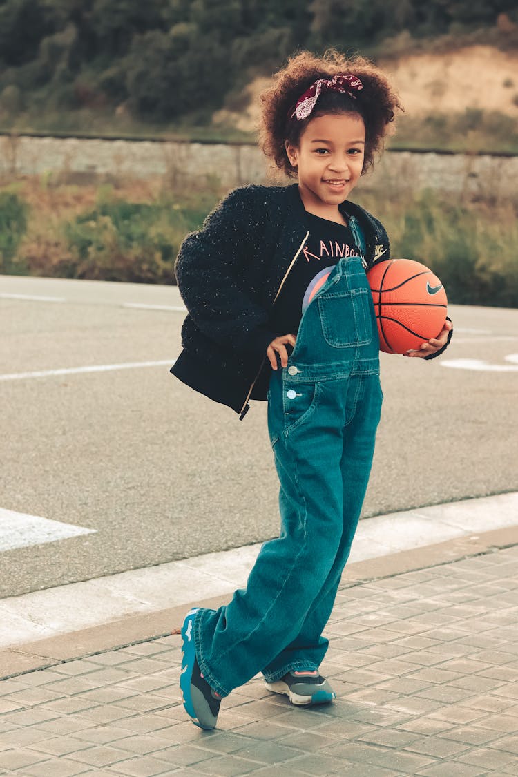 Young Girl Holding A Basketball