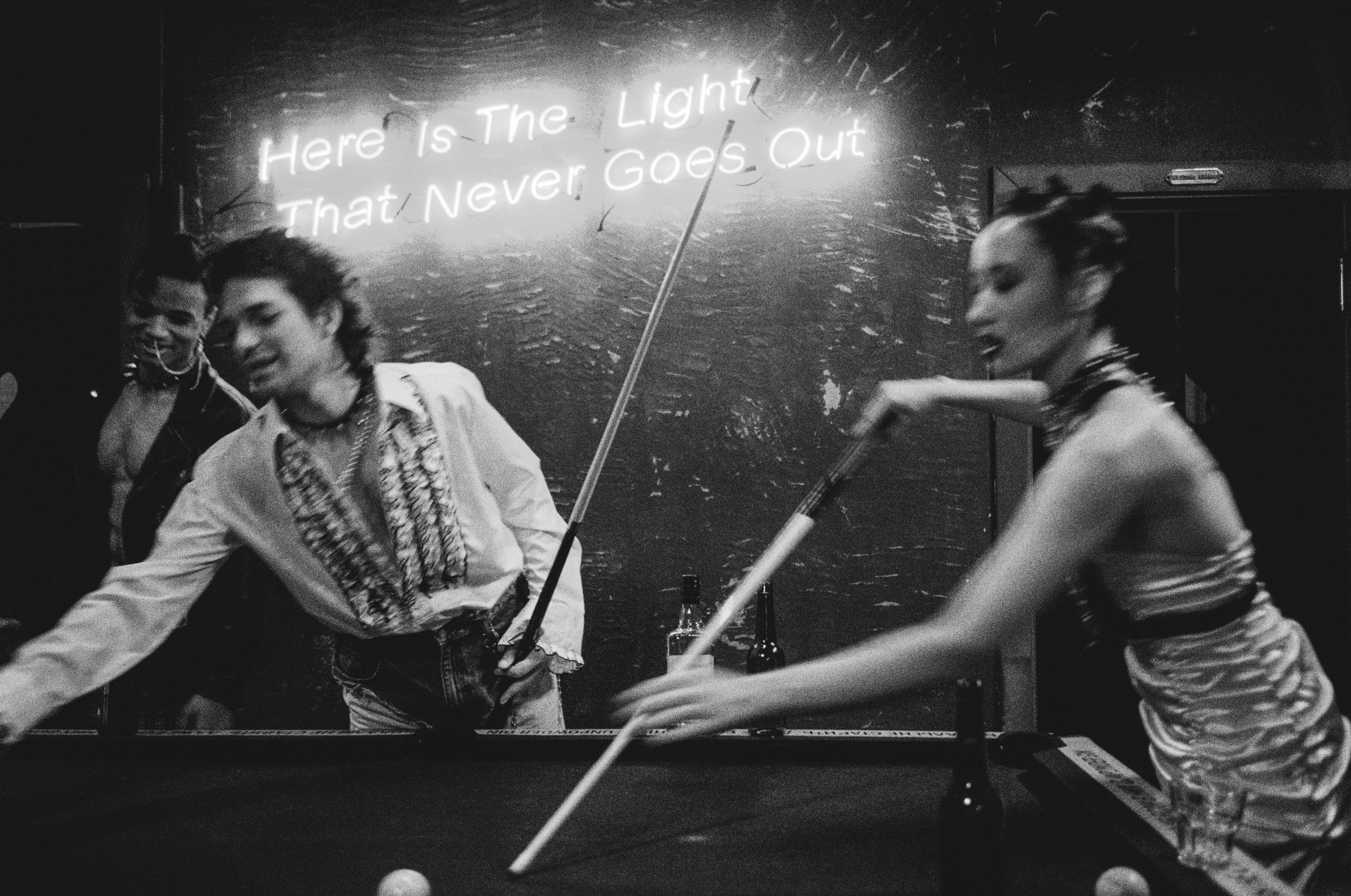 couple playing billiards