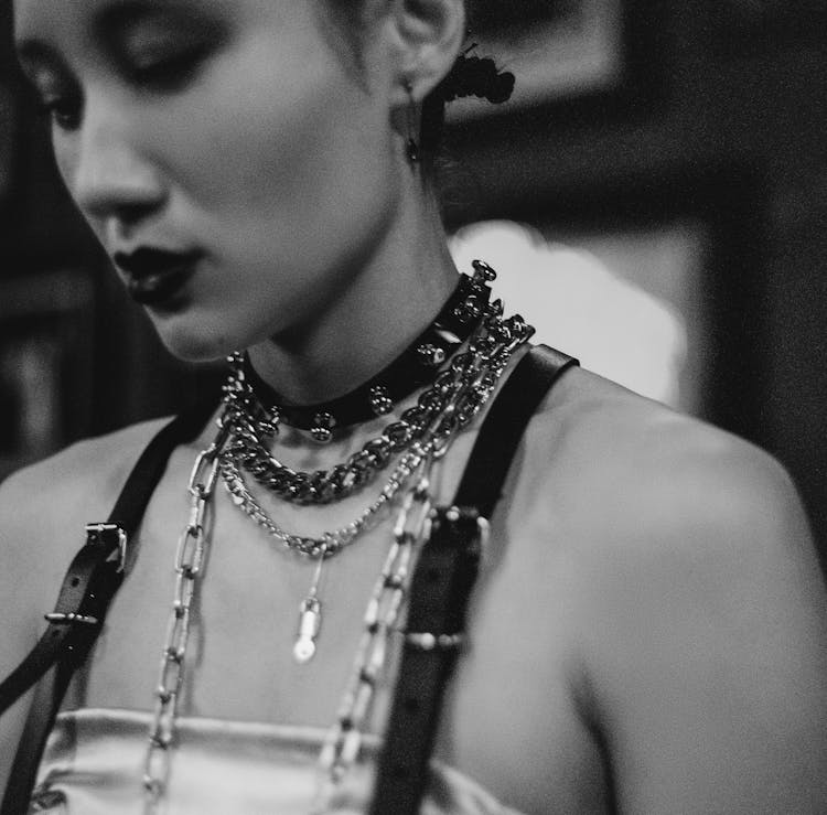 
A Grayscale Of A Woman Wearing Necklaces And A Choker