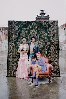 Stylized portrait of fashion models with punk elements in an urban setting.