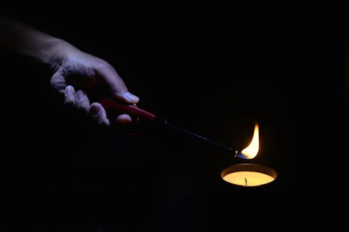 Free stock photo of candle, hand with lighter, light